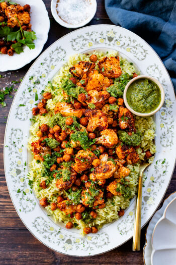 This Roasted Cauliflower with Chimichurri Rice is a flavor packed meal! Cauliflower & chickpeas seasoned and roasted until crispy over herby rice | ThisSavoryVegan.com #chimichurrirecipe #roastedcauliflower #veggiedinner
