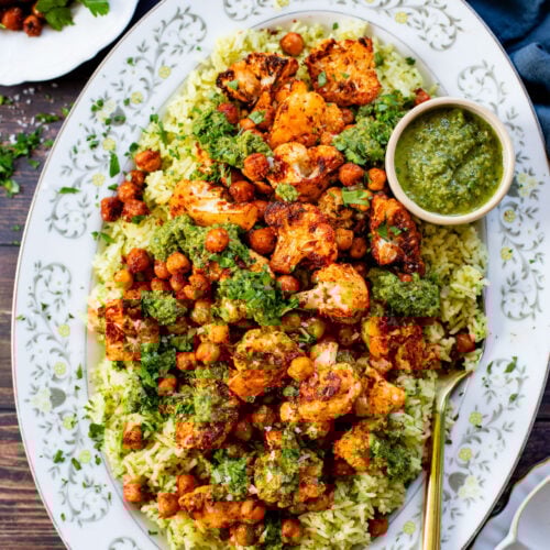 This Roasted Cauliflower with Chimichurri Rice is a flavor packed meal! Cauliflower & chickpeas seasoned and roasted until crispy over herby rice | ThisSavoryVegan.com #chimichurrirecipe #roastedcauliflower #veggiedinner