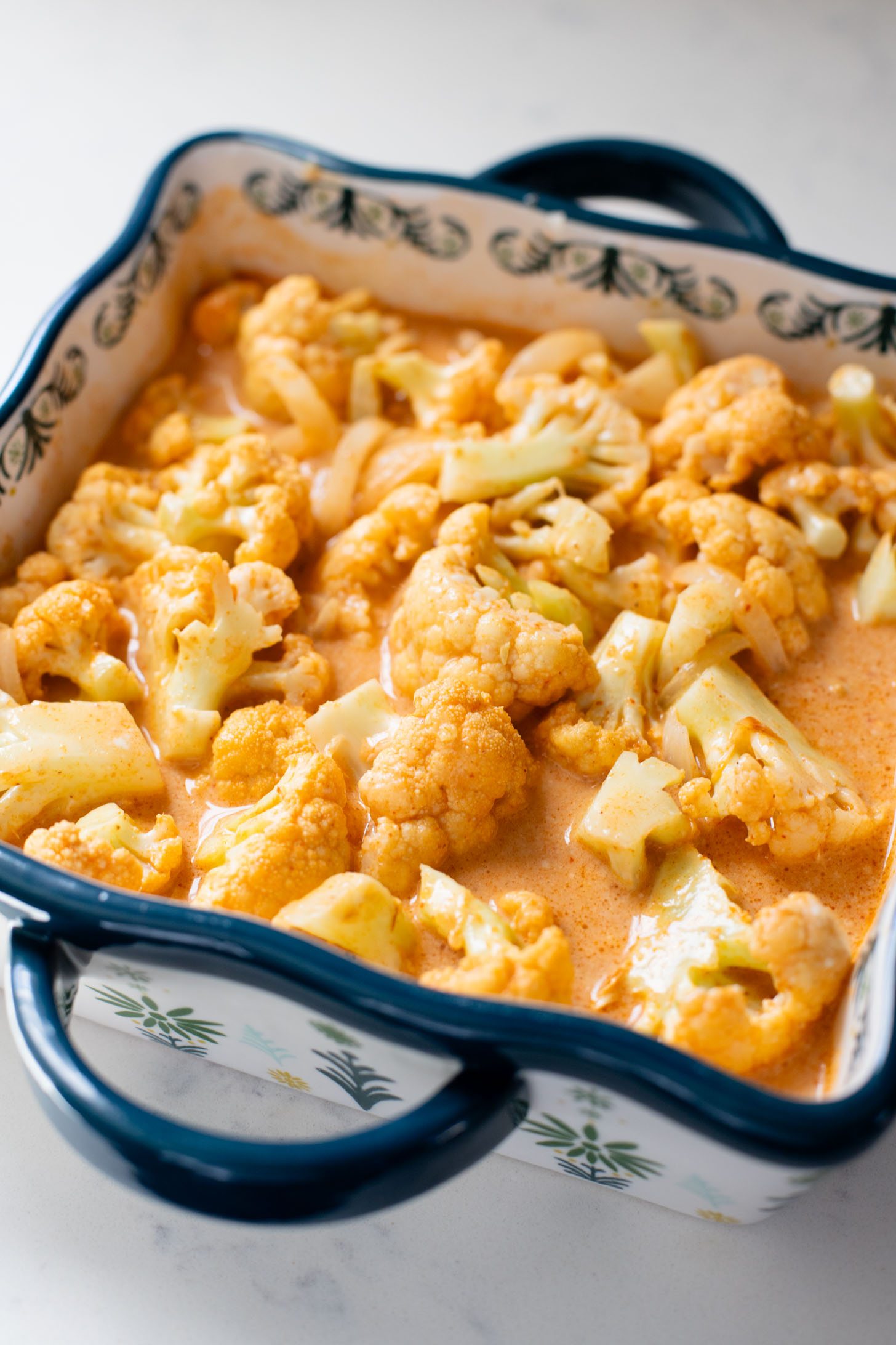 This Roasted Red Curry Cauliflower is a simple & delicious veggie dish. Cauliflower is tossed in a red curry coconut sauce & roasted. Serve with rice | ThisSavoryVegan.com #thissavoryvegan #cauliflowerrecipes #veggierecipes