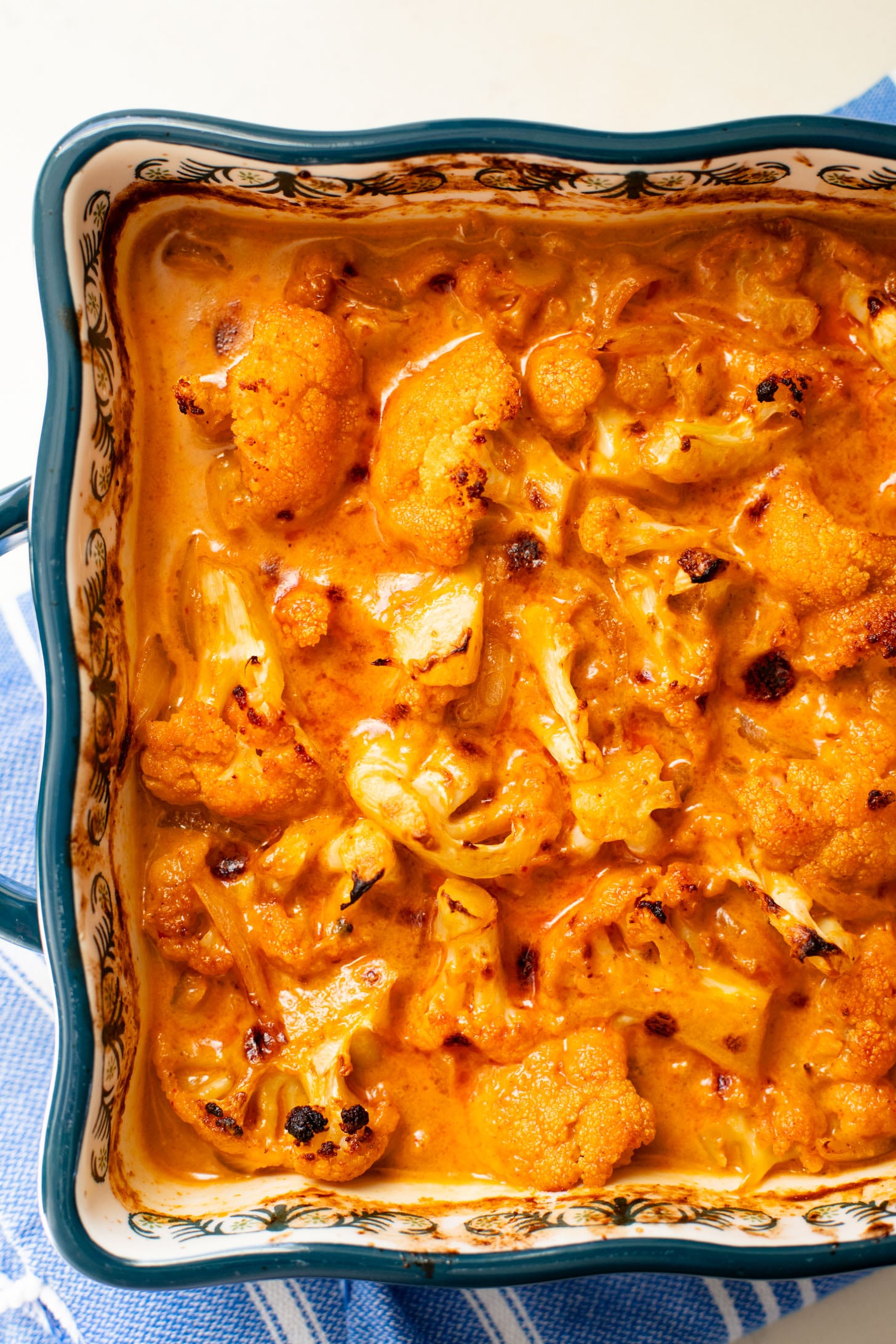 This Roasted Red Curry Cauliflower is a simple & delicious veggie dish. Cauliflower is tossed in a red curry coconut sauce & roasted. Serve with rice | ThisSavoryVegan.com #thissavoryvegan #cauliflowerrecipes #veggierecipes