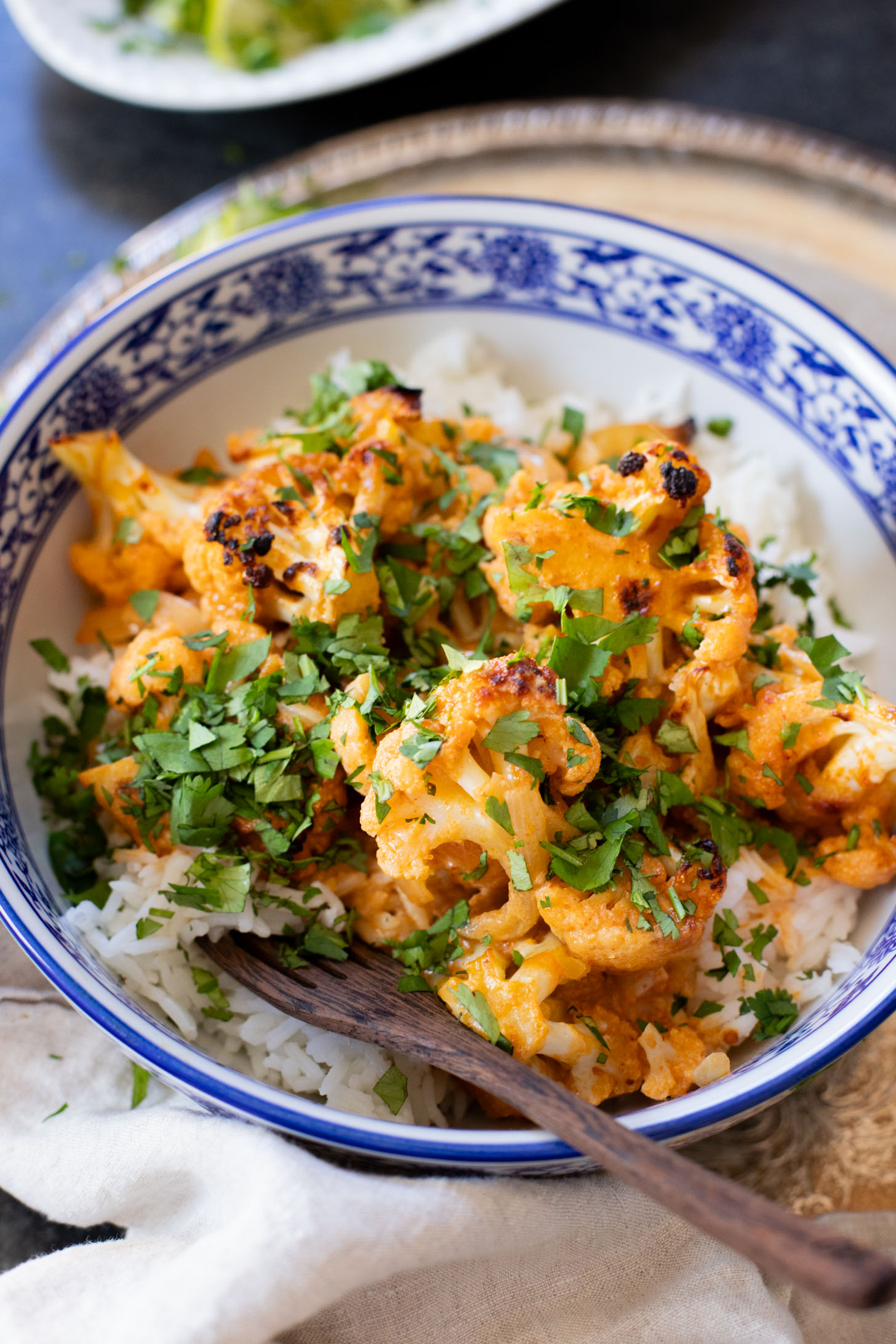 This Roasted Red Curry Cauliflower is a simple & delicious veggie dish. Cauliflower is tossed in a red curry coconut sauce & roasted. Serve with rice | ThisSavoryVegan.com #thissavoryvegan #cauliflowerrecipes #veggierecipes