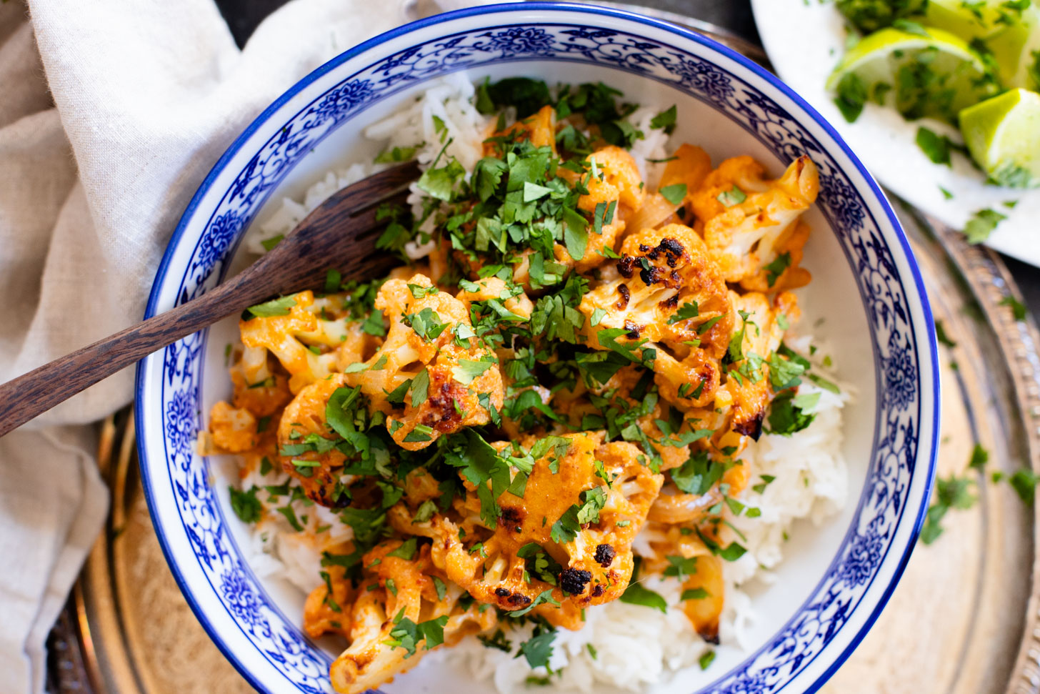 This Roasted Red Curry Cauliflower is a simple & delicious veggie dish. Cauliflower is tossed in a red curry coconut sauce & roasted. Serve with rice | ThisSavoryVegan.com #thissavoryvegan #cauliflowerrecipes #veggierecipes