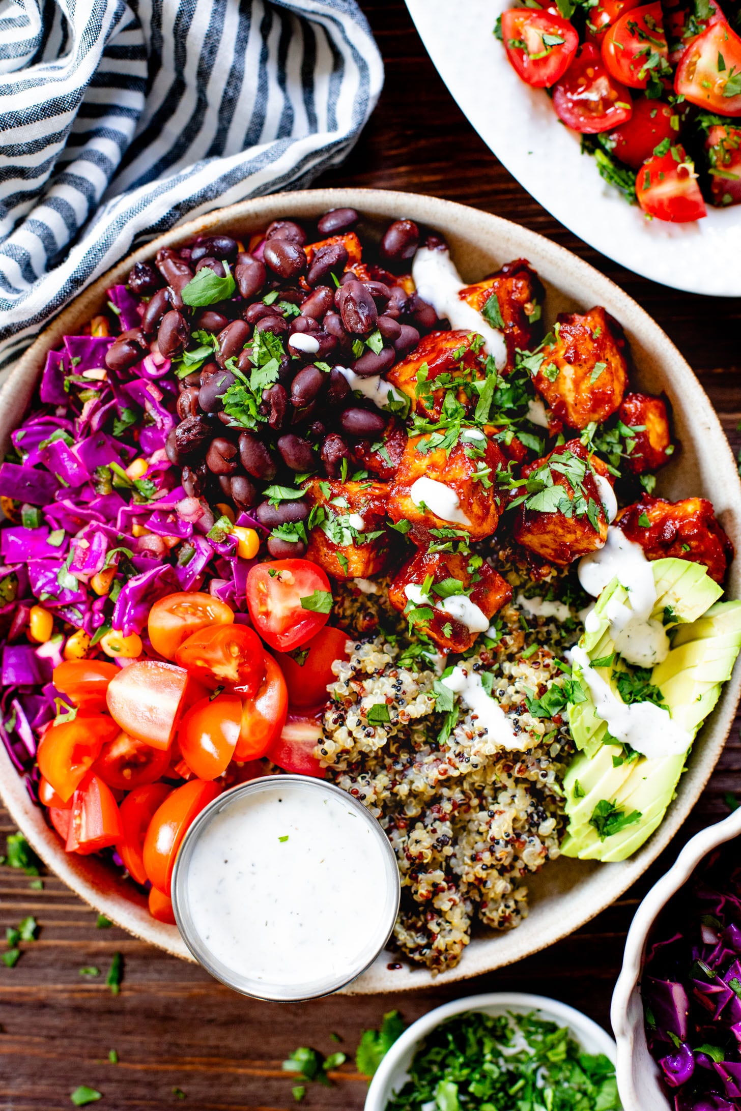 These BBQ Tofu Quinoa Bowls are layered with saucy BBQ tofu, quinoa, black beans, corn & cabbage slaw, tomatoes, avocado & vegan ranch | ThisSavoryVegan.com #thissavoryvegan #quinoabowl #easyveganrecipes