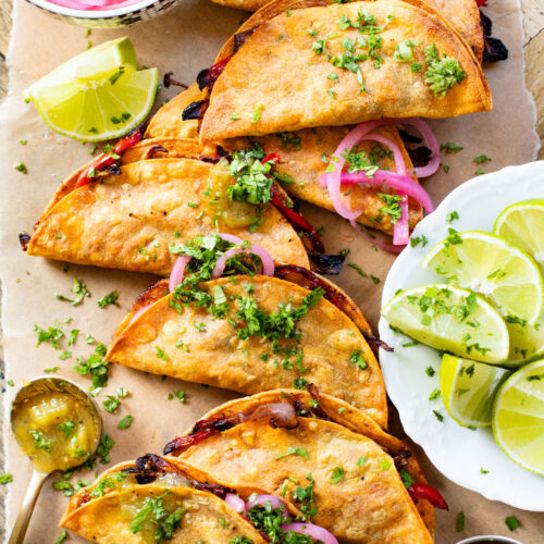 These Crispy Oyster Mushroom Tacos are a veggie dream! Roasted veggies are layered in corn tortillas & baked until crispy. Taco Tuesday goals | ThisSavoryVegan.com #thissavoryvegan #vegantacos #mushroomtacos