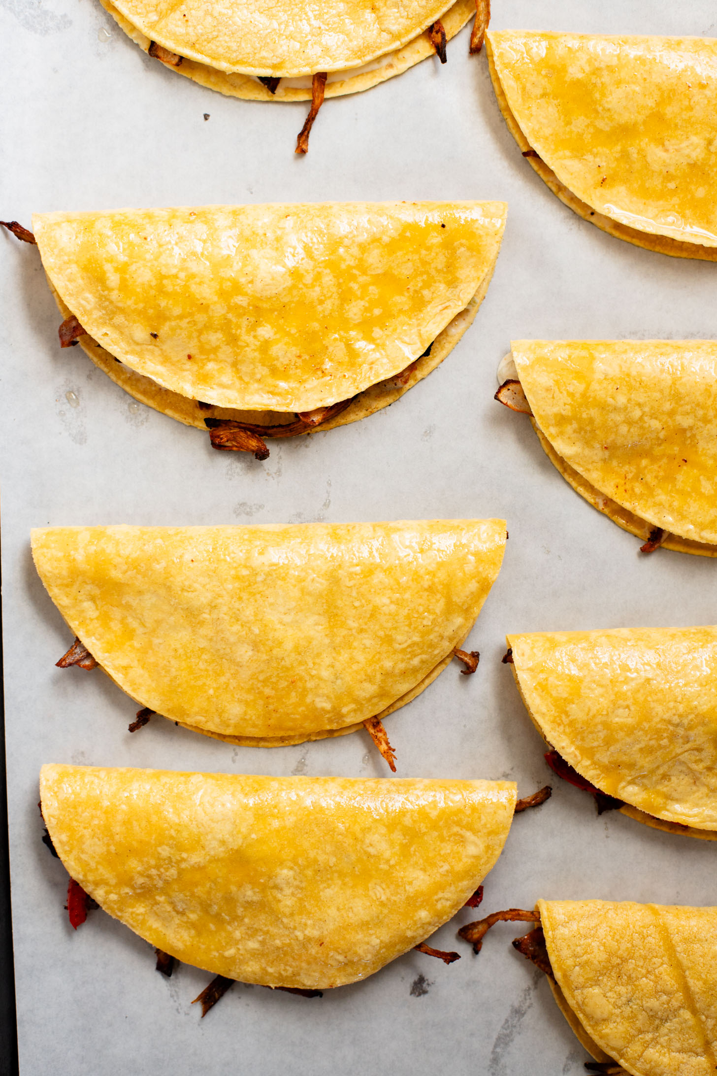 These Crispy Oyster Mushroom Tacos are a veggie dream! Roasted veggies are layered in corn tortillas & baked until crispy. Taco Tuesday goals | ThisSavoryVegan.com #thissavoryvegan #vegantacos #mushroomtacos