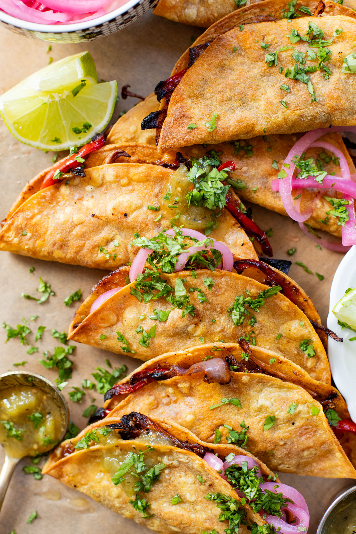 These Crispy Oyster Mushroom Tacos are a veggie dream! Roasted veggies are layered in corn tortillas & baked until crispy. Taco Tuesday goals | ThisSavoryVegan.com #thissavoryvegan #vegantacos #mushroomtacos