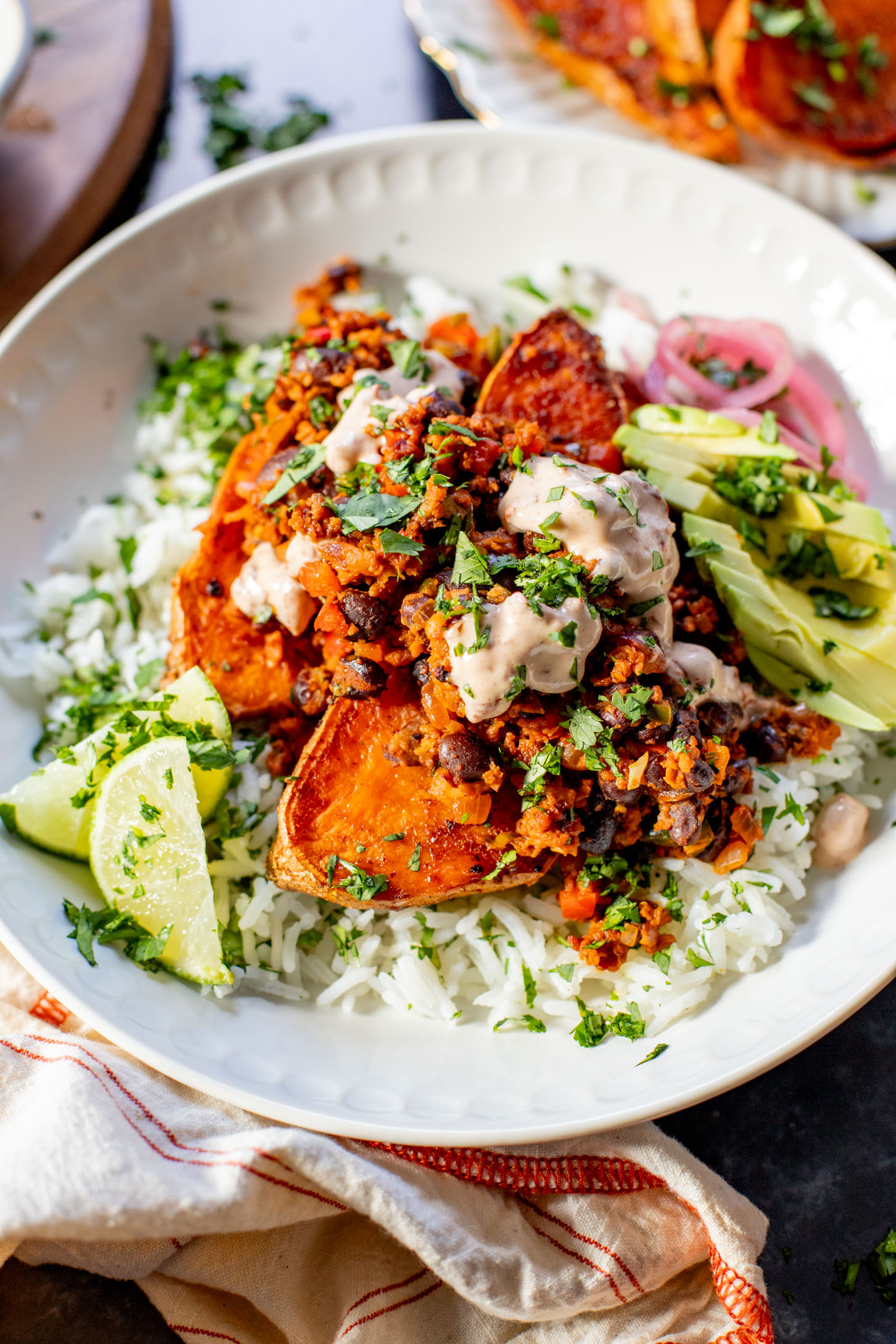 These Taco Stuffed Sweet Potatoes are a healthy and delicious vegan dinner idea. Filled with beans, cilantro lime rice, soyrizo & veggies | ThisSavoryVegan.com #thissavoryvegan #healthydinner #sweetpotatorecipes