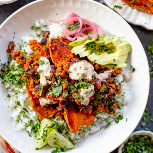 These Taco Stuffed Sweet Potatoes are a healthy and delicious vegan dinner idea. Filled with beans, cilantro lime rice, soyrizo & veggies | ThisSavoryVegan.com #thissavoryvegan #healthydinner #sweetpotatorecipes