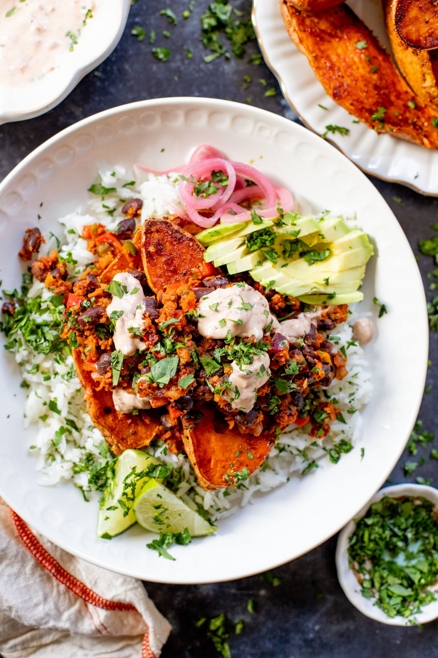 These Taco Stuffed Sweet Potatoes are a healthy and delicious vegan dinner idea. Filled with beans, cilantro lime rice, soyrizo & veggies | ThisSavoryVegan.com #thissavoryvegan #healthydinner #sweetpotatorecipes