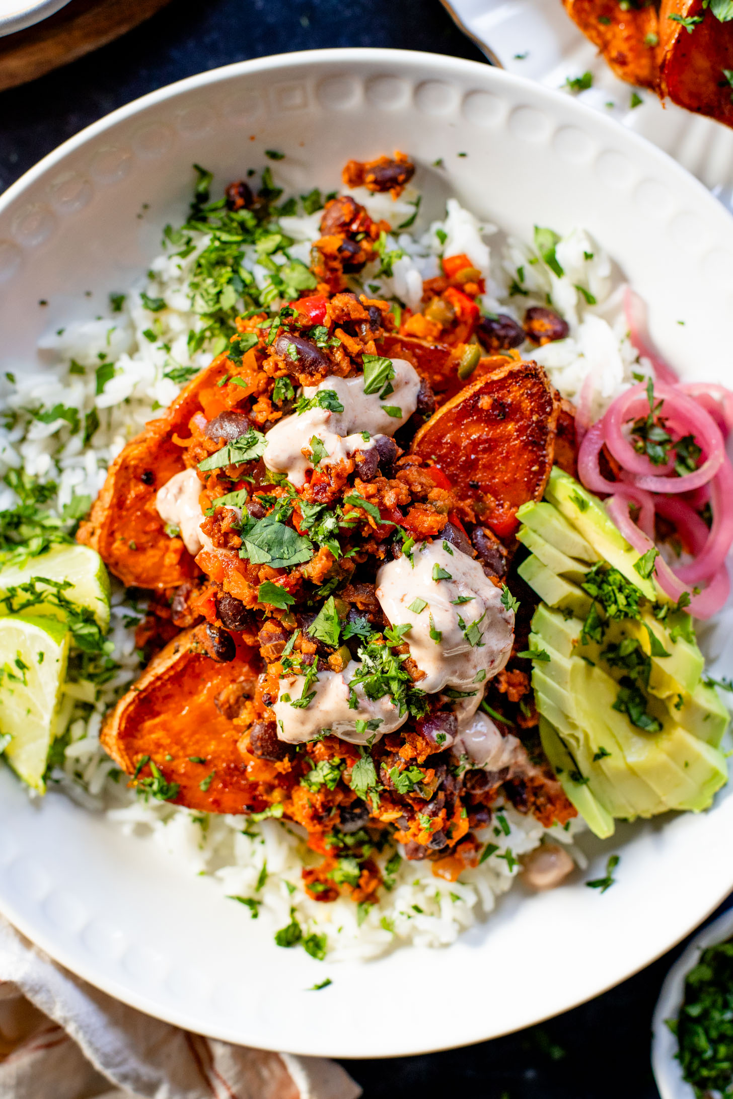 These Taco Stuffed Sweet Potatoes are a healthy and delicious vegan dinner idea. Filled with beans, cilantro lime rice, soyrizo & veggies | ThisSavoryVegan.com #thissavoryvegan #healthydinner #sweetpotatorecipes