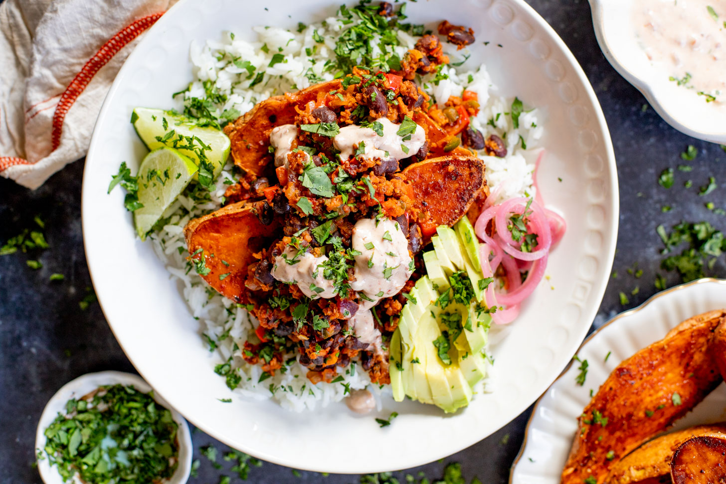 These Taco Stuffed Sweet Potatoes are a healthy and delicious vegan dinner idea. Filled with beans, cilantro lime rice, soyrizo & veggies | ThisSavoryVegan.com #thissavoryvegan #healthydinner #sweetpotatorecipes