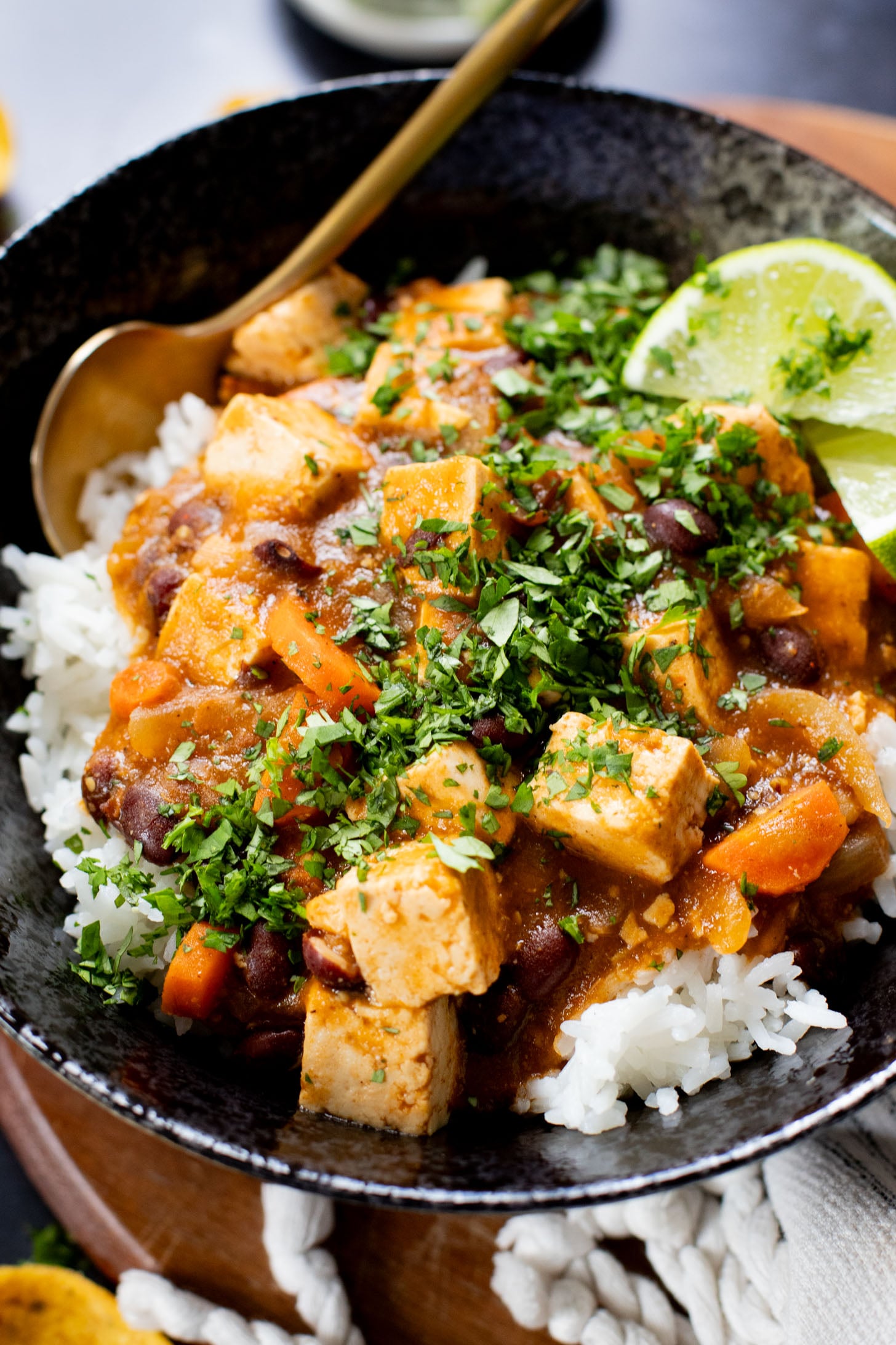 This Tofu Chile Verde is a stew made with green chiles, green enchilada sauce, veggies, tofu & black beans. A healthy & easy vegan dinner | ThisSavoryVegan.com #thissavoryvegan #highproteinveganrecipes #veganstew