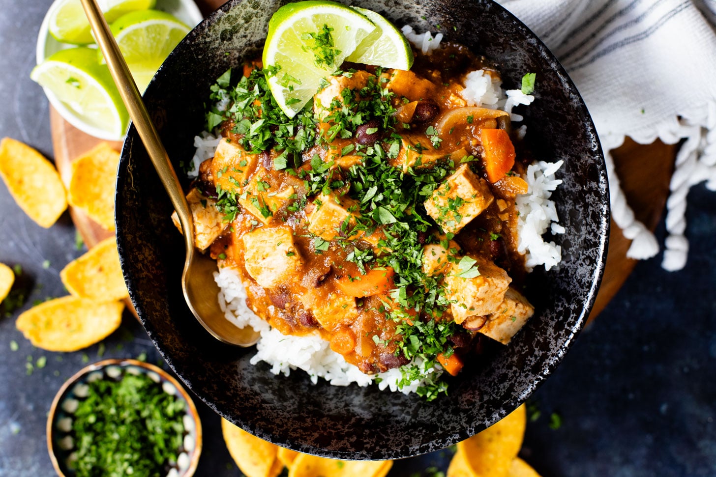 This Tofu Chile Verde is a stew made with green chiles, green enchilada sauce, veggies, tofu & black beans. A healthy & easy vegan dinner | ThisSavoryVegan.com #thissavoryvegan #highproteinveganrecipes #veganstew