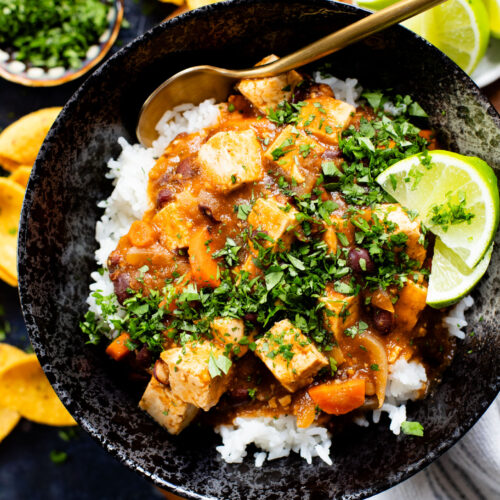 This Tofu Chile Verde is a stew made with green chiles, green enchilada sauce, veggies, tofu & black beans. A healthy & easy vegan dinner | ThisSavoryVegan.com #thissavoryvegan #highproteinveganrecipes #veganstew