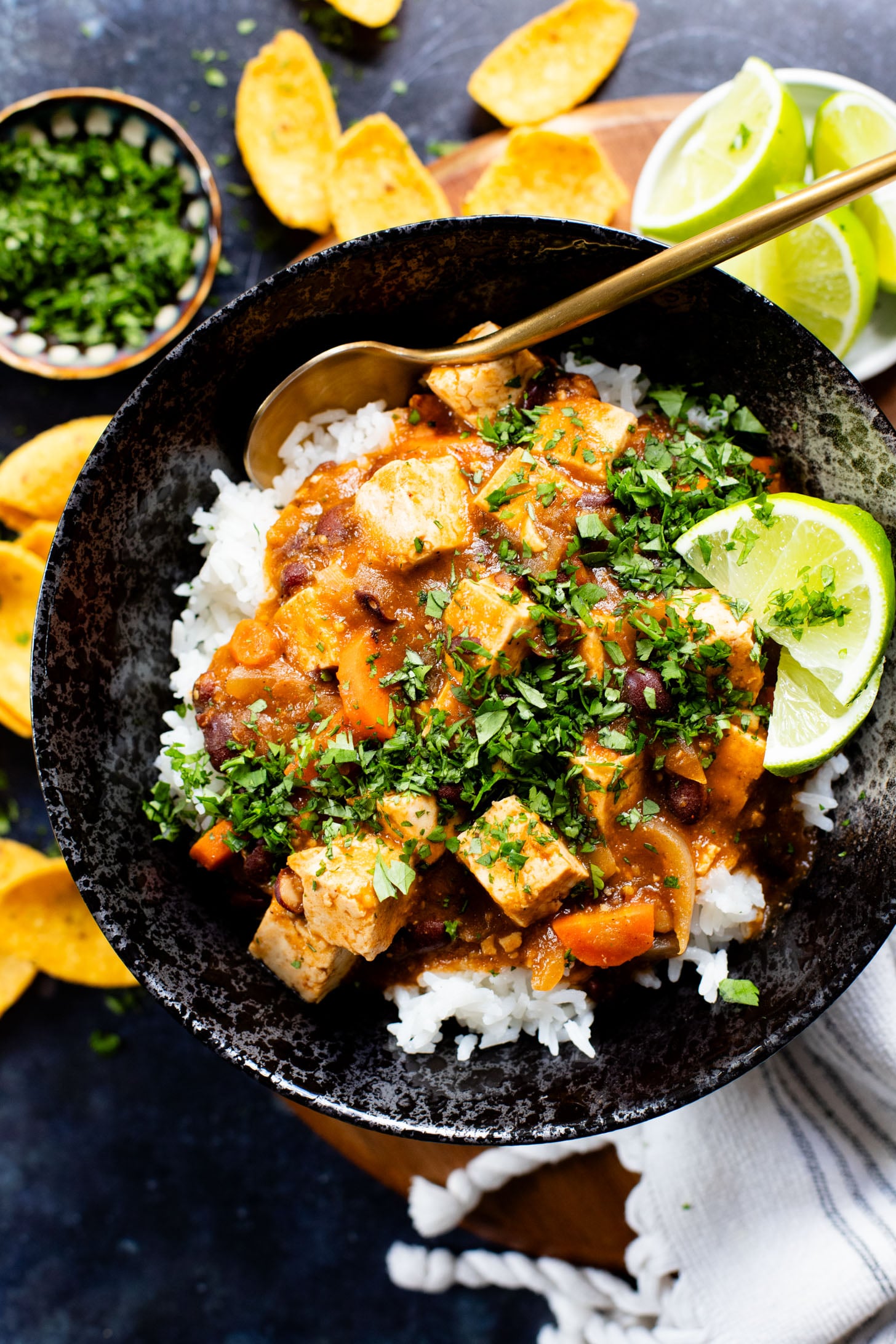 This Tofu Chile Verde is a stew made with green chiles, green enchilada sauce, veggies, tofu & black beans. A healthy & easy vegan dinner | ThisSavoryVegan.com #thissavoryvegan #highproteinveganrecipes #veganstew