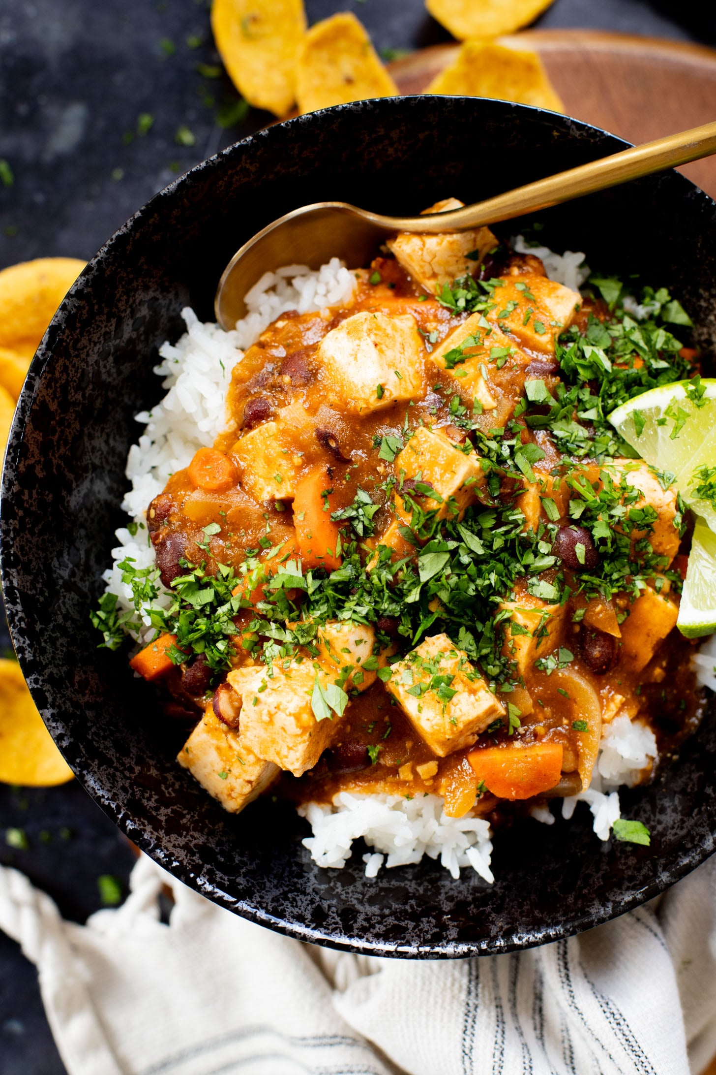 This Tofu Chile Verde is a stew made with green chiles, green enchilada sauce, veggies, tofu & black beans. A healthy & easy vegan dinner | ThisSavoryVegan.com #thissavoryvegan #highproteinveganrecipes #veganstew
