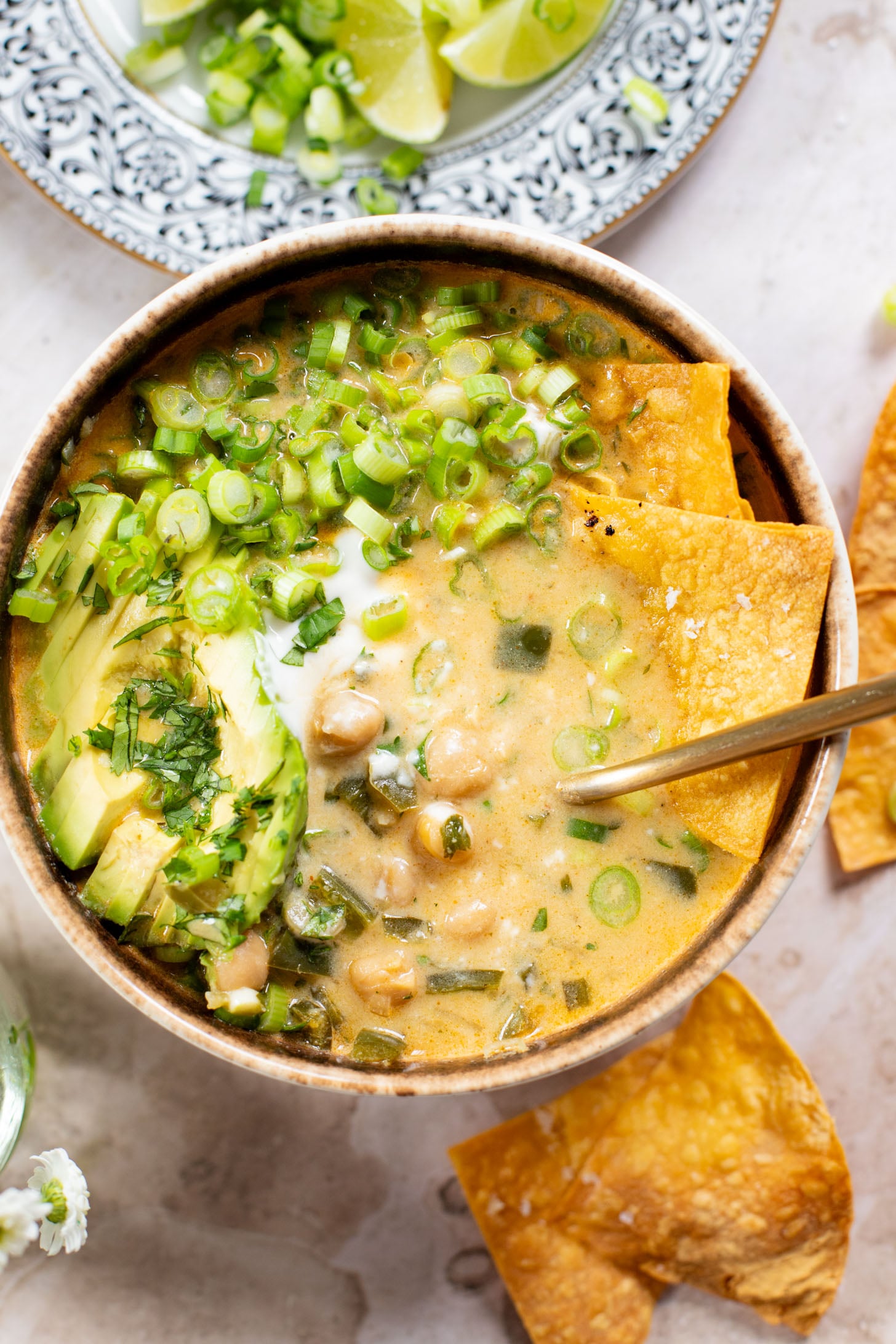 This simple, one-pot White Chickpea Chili is creamy & delicious. The perfect bowl of coziness to serve up on a cold day - don't forget the tortillas chips | ThisSavoryVegan.com #thissavoryvegan #veganchili #chickpearecipes