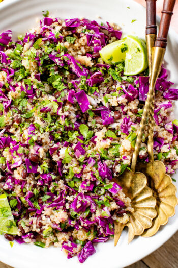This Black Bean Quinoa Salad is filled with crunchy veggies, a light lime dressing, black beans and chilled quinoa. The perfect lunch or dinner | ThisSavoryVegan.com