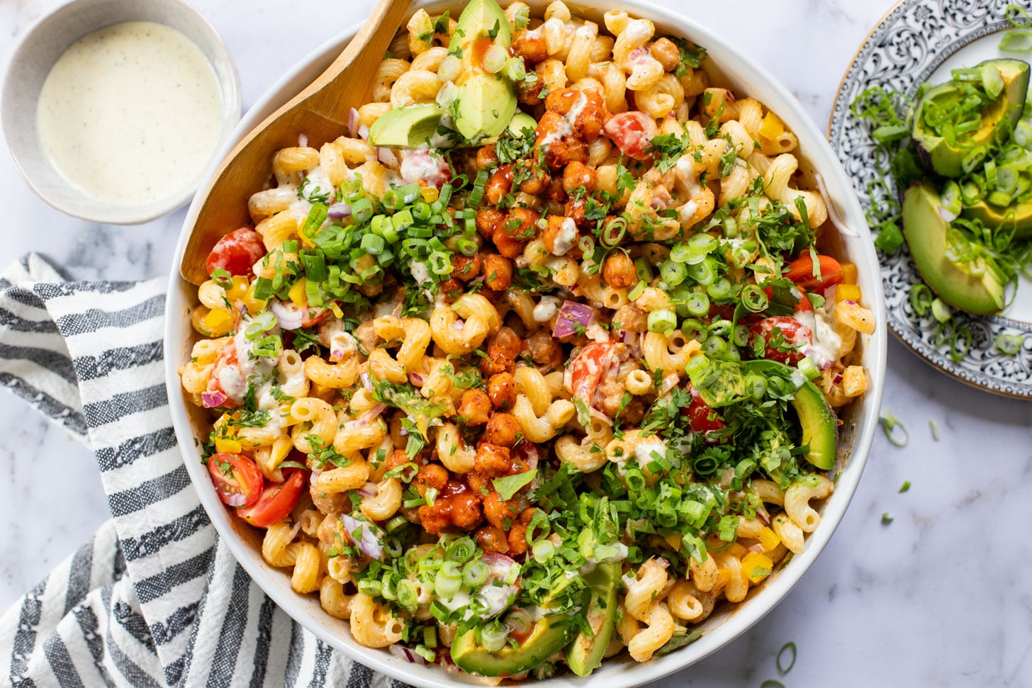 This Buffalo Chickpea Pasta Salad is the ultimate vegan salad! Made with crispy buffalo chickpeas, dairy-free green chile ranch, pasta & veggies | ThisSavoryVegan.com