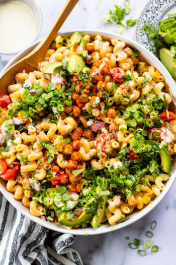 This Buffalo Chickpea Pasta Salad is the ultimate vegan salad! Made with crispy buffalo chickpeas, dairy-free green chile ranch, pasta & veggies | ThisSavoryVegan.com