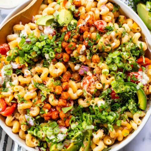 This Buffalo Chickpea Pasta Salad is the ultimate vegan salad! Made with crispy buffalo chickpeas, dairy-free green chile ranch, pasta & veggies | ThisSavoryVegan.com
