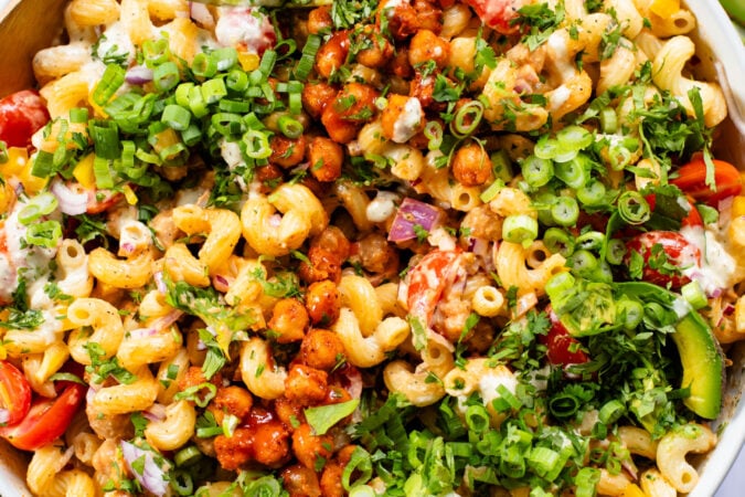 This Buffalo Chickpea Pasta Salad is the ultimate vegan salad! Made with crispy buffalo chickpeas, dairy-free green chile ranch, pasta & veggies | ThisSavoryVegan.com