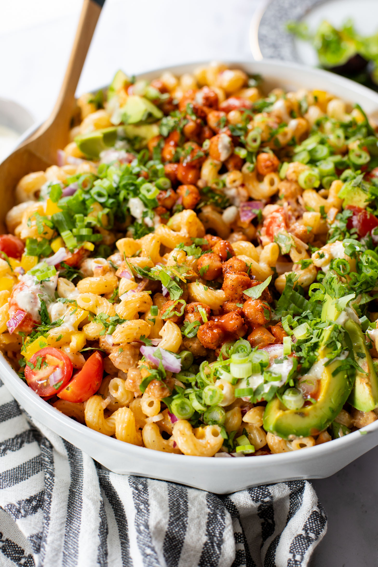 This Buffalo Chickpea Pasta Salad is the ultimate vegan salad! Made with crispy buffalo chickpeas, dairy-free green chile ranch, pasta & veggies | ThisSavoryVegan.com