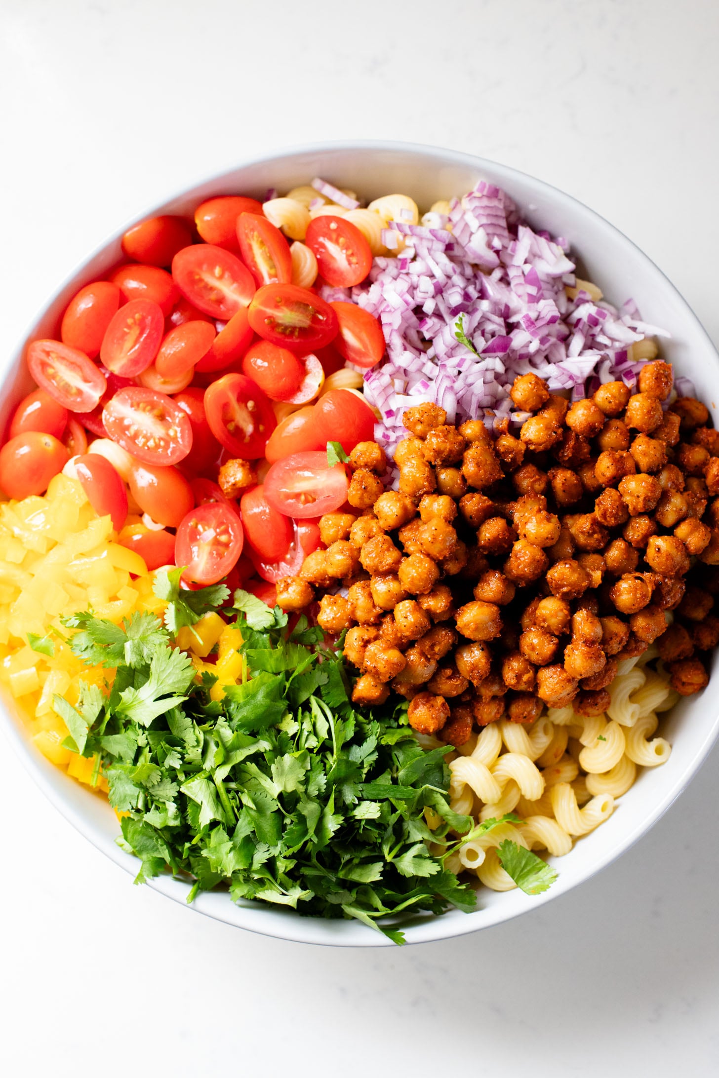 This Buffalo Chickpea Pasta Salad is the ultimate vegan salad! Made with crispy buffalo chickpeas, dairy-free green chile ranch, pasta & veggies | ThisSavoryVegan.com