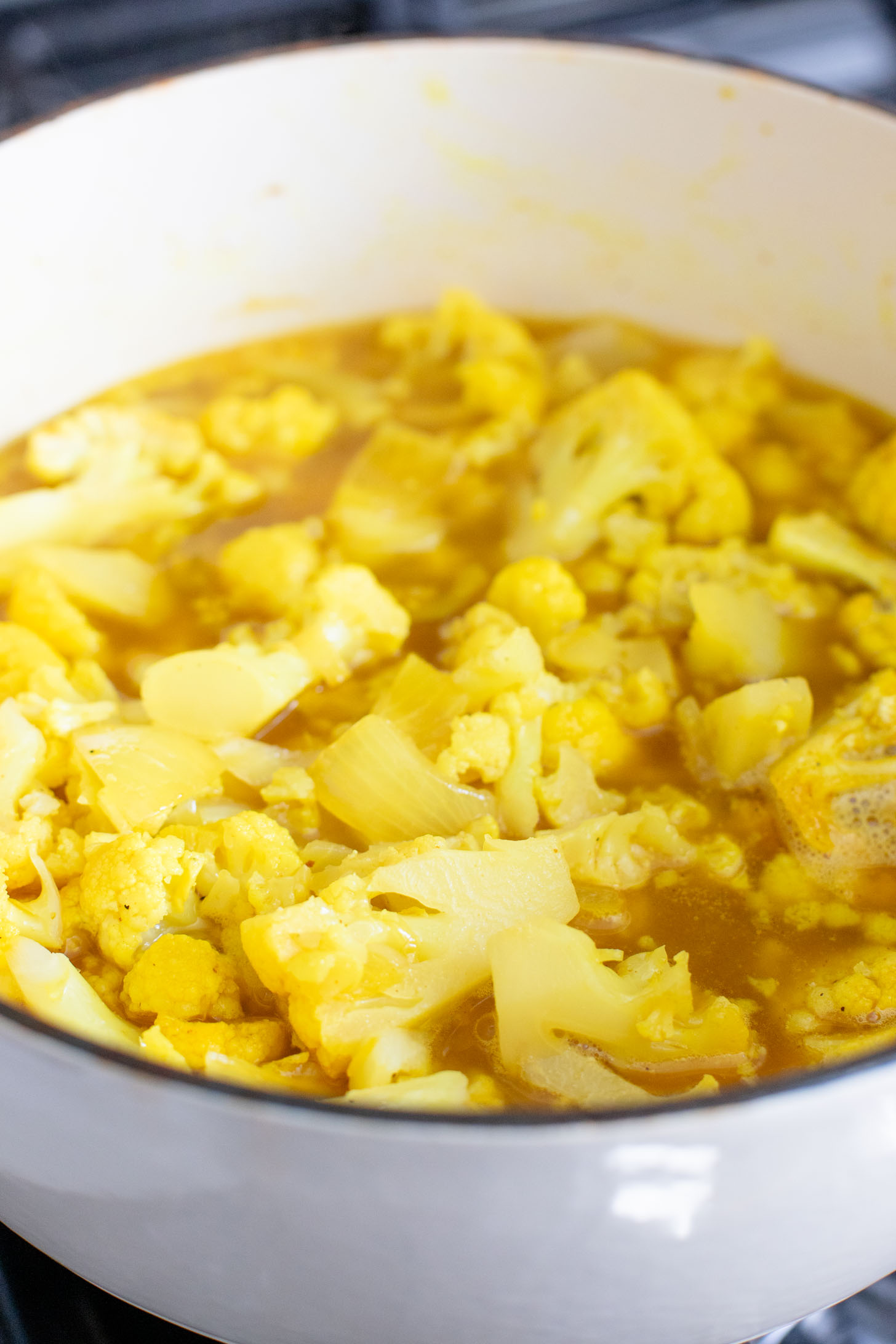 This Creamy Curried Cauliflower Soup is veggie-packed and dairy-free. A delicious, creamy vegan soup that is ready in less than an hour | ThisSavoryVegan.com