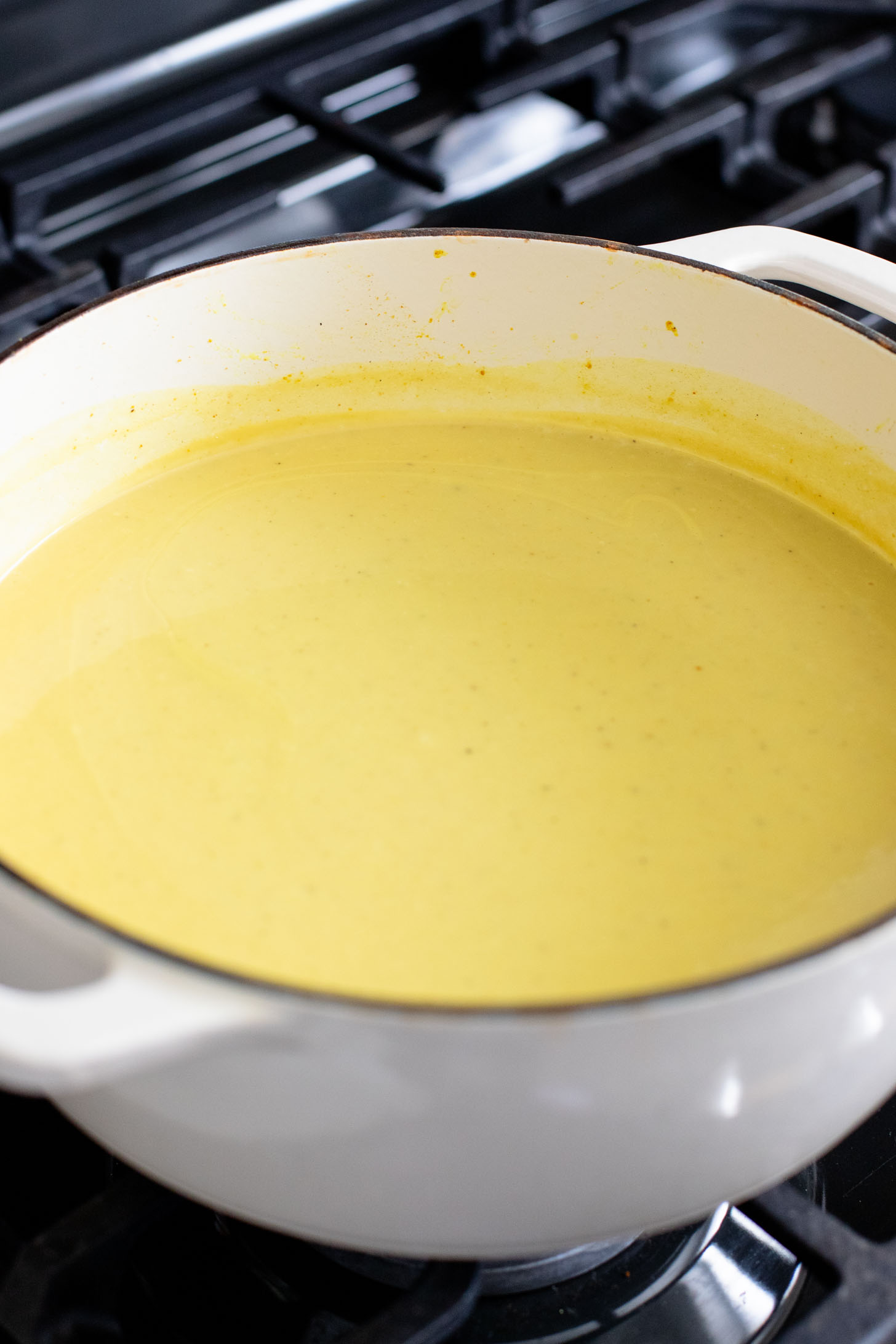 This Creamy Curried Cauliflower Soup is veggie-packed and dairy-free. A delicious, creamy vegan soup that is ready in less than an hour | ThisSavoryVegan.com