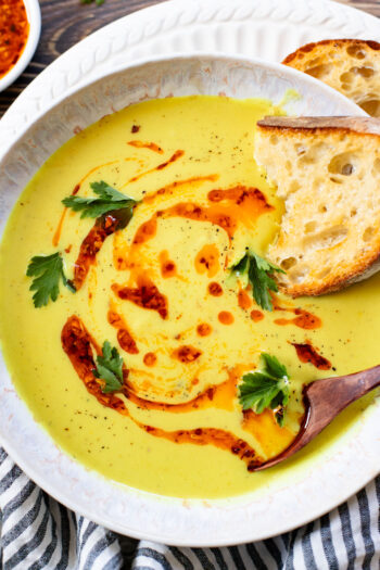This Creamy Curried Cauliflower Soup is veggie-packed and dairy-free. A delicious, creamy vegan soup that is ready in less than an hour | ThisSavoryVegan.com