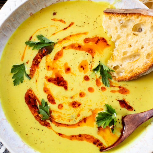 This Creamy Curried Cauliflower Soup is veggie-packed and dairy-free. A delicious, creamy vegan soup that is ready in less than an hour | ThisSavoryVegan.com