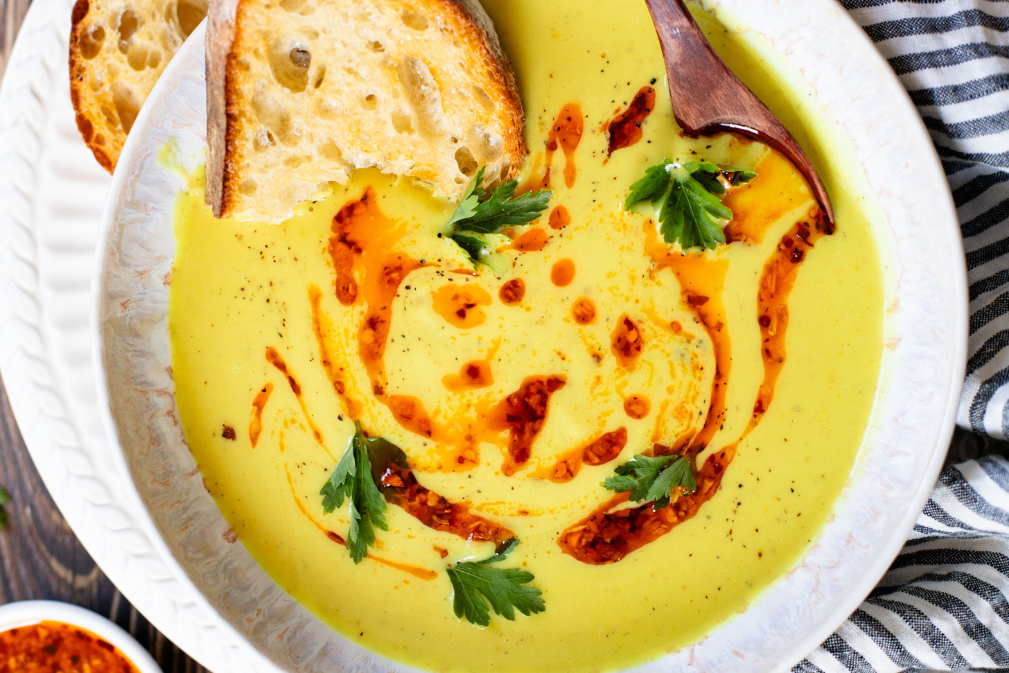 This Creamy Curried Cauliflower Soup is veggie-packed and dairy-free. A delicious, creamy vegan soup that is ready in less than an hour | ThisSavoryVegan.com