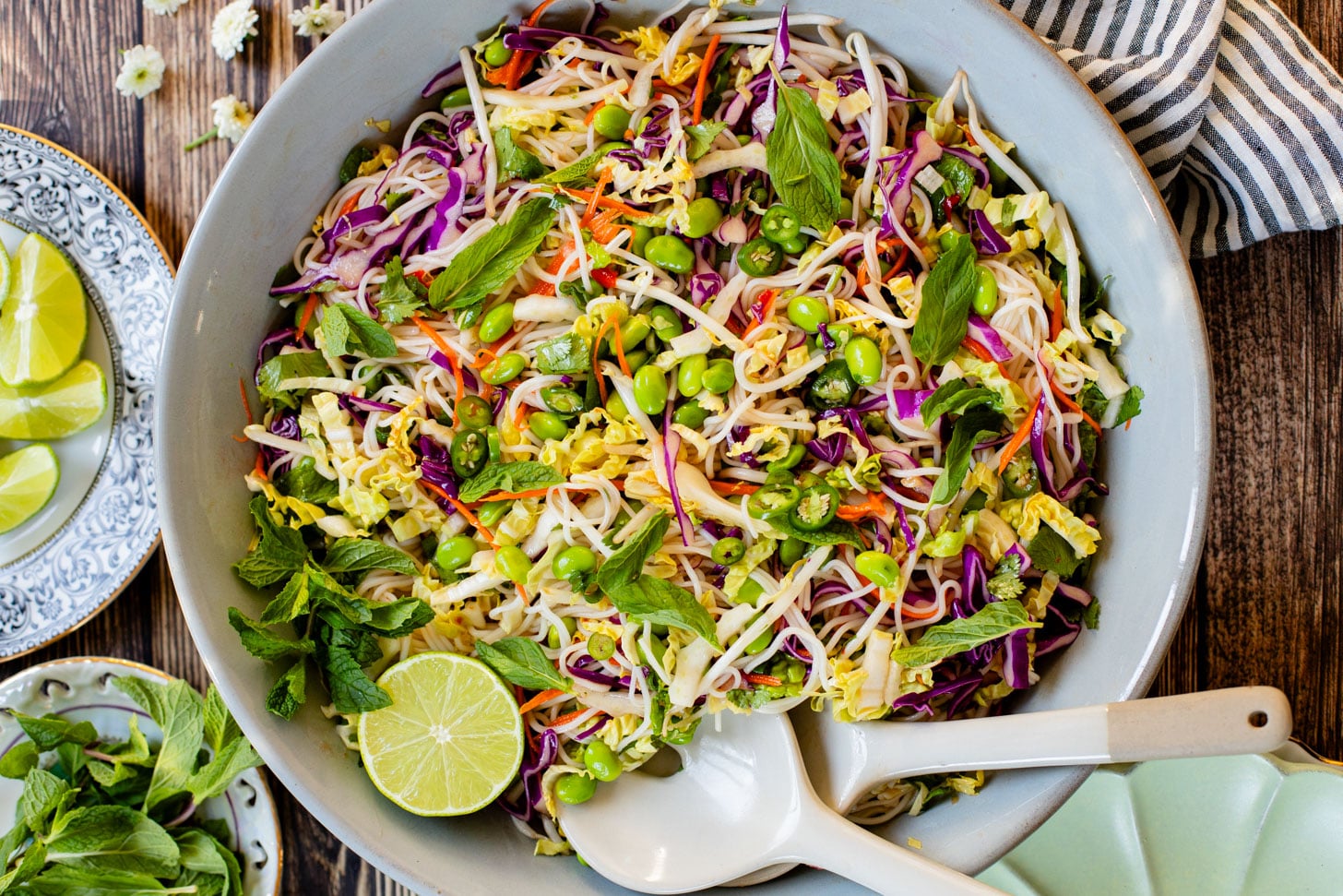 This Edamame Rice Noodle Salad is veggie (and protein) packed. Made with rice noodles and served with a sweet chili lime dressing | ThisSavoryVegan.com
