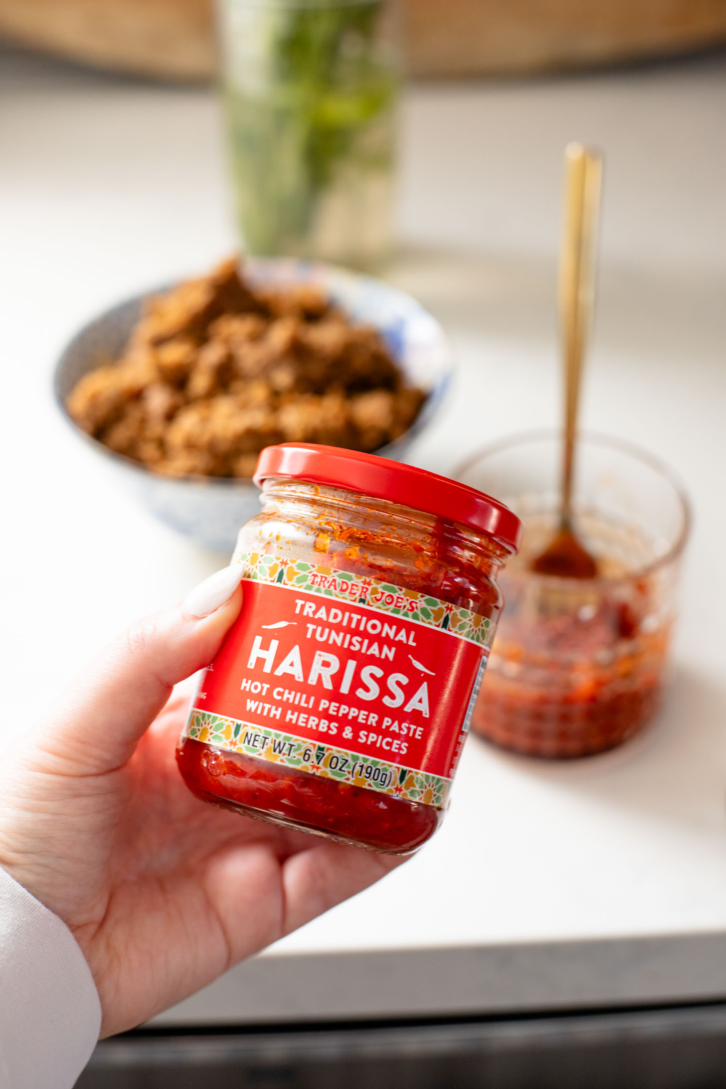 These Vegan Harissa Beef Couscous Bowls are layered with lemon couscous, hummus, veggies, "beef" crumbles and vegan feta sauce | ThisSavoryVegan.com