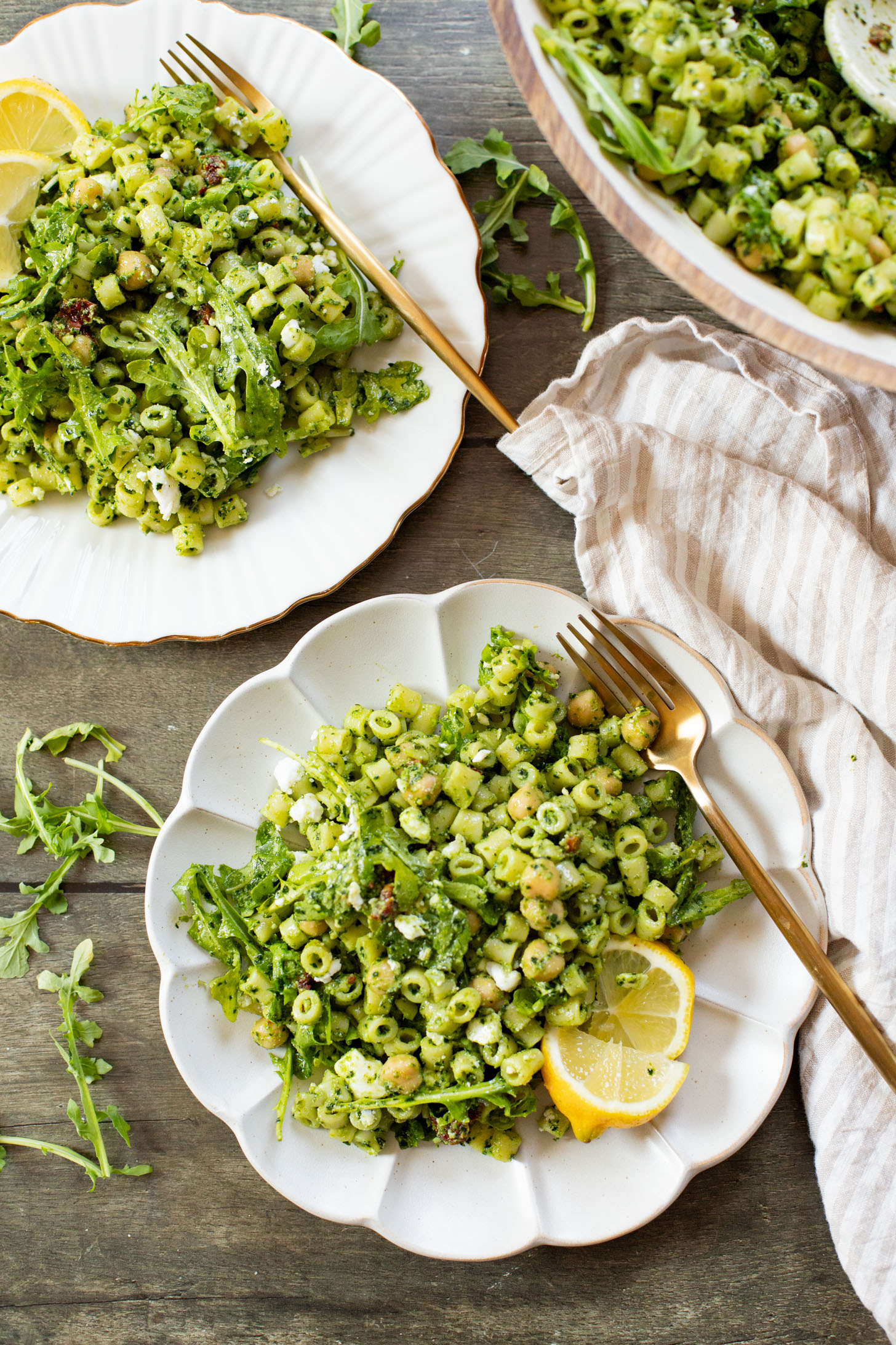This Kale Pesto Pasta Salad is made with a dairy-free, earthy kale & basil pesto, vegan feta, chickpeas, sun-dried tomatoes & arugula | ThisSavoryVegan.com