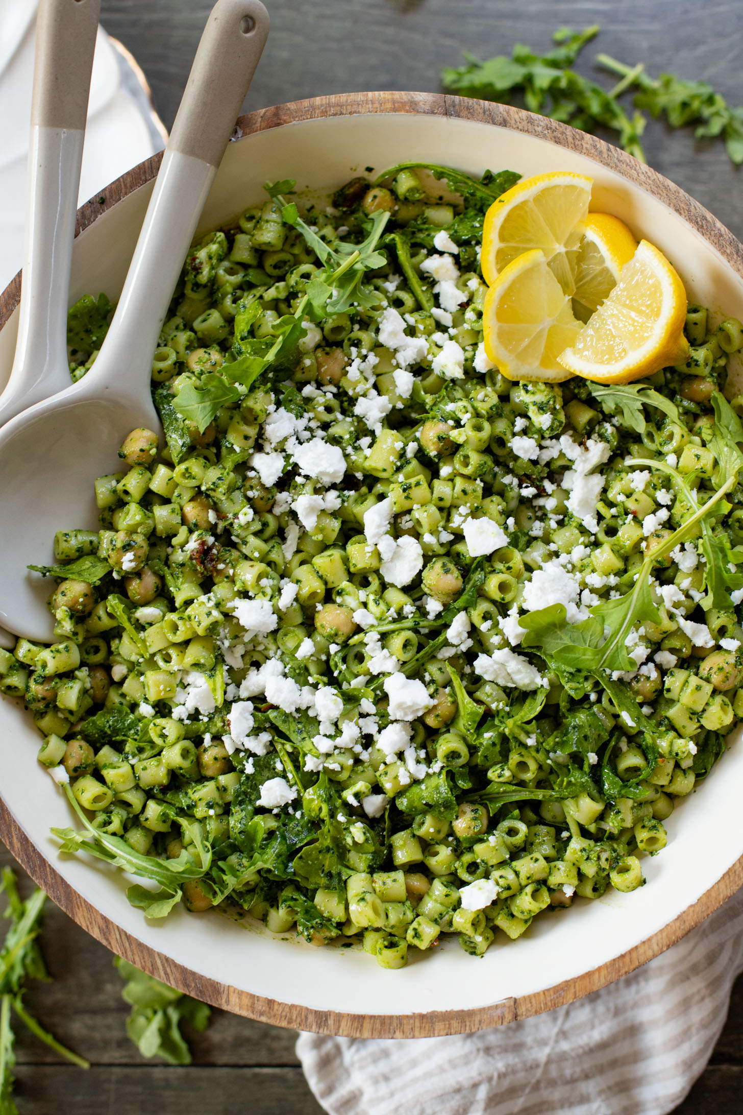 This Kale Pesto Pasta Salad is made with a dairy-free, earthy kale & basil pesto, vegan feta, chickpeas, sun-dried tomatoes & arugula | ThisSavoryVegan.com