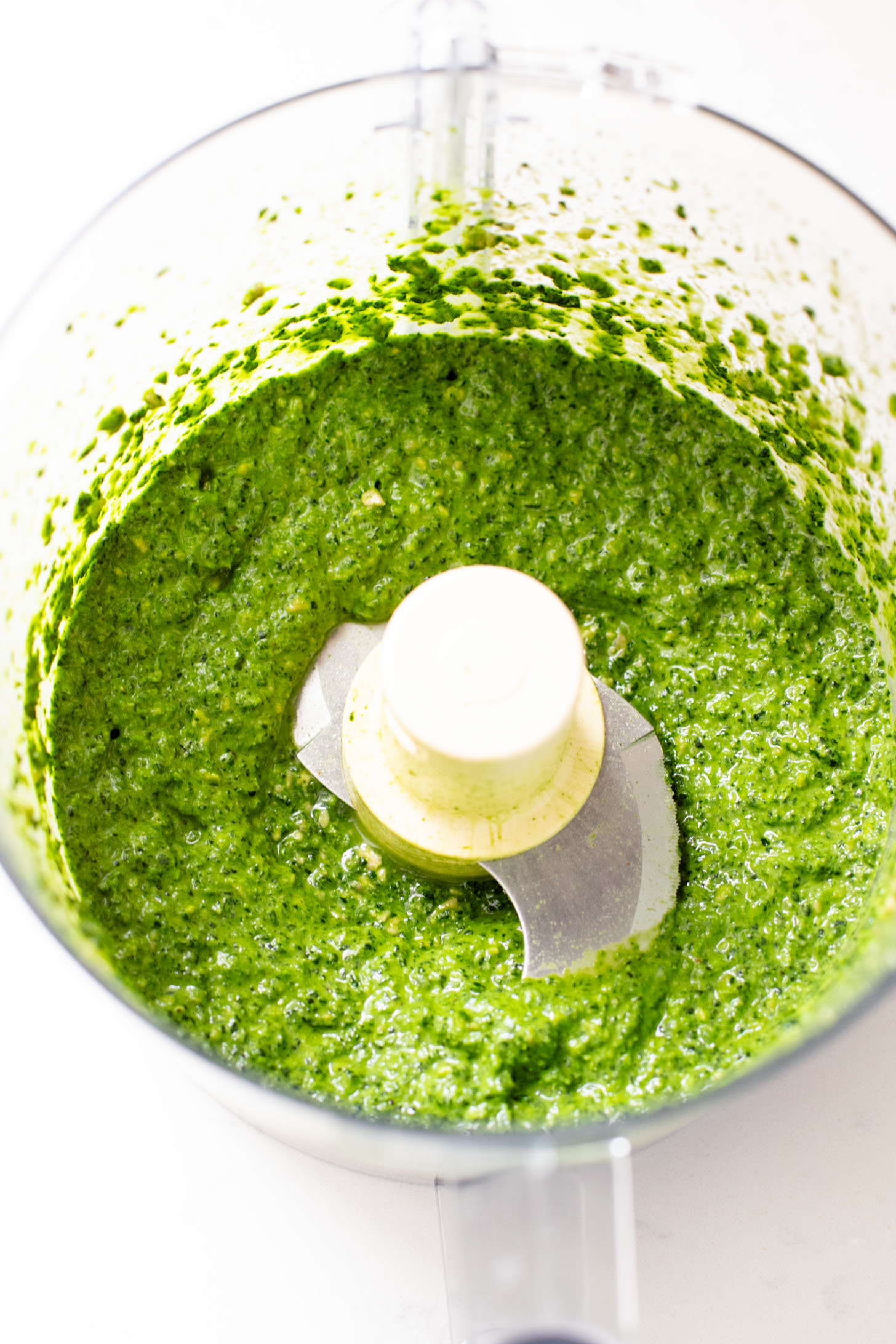 This Kale Pesto Pasta Salad is made with a dairy-free, earthy kale & basil pesto, vegan feta, chickpeas, sun-dried tomatoes & arugula | ThisSavoryVegan.com