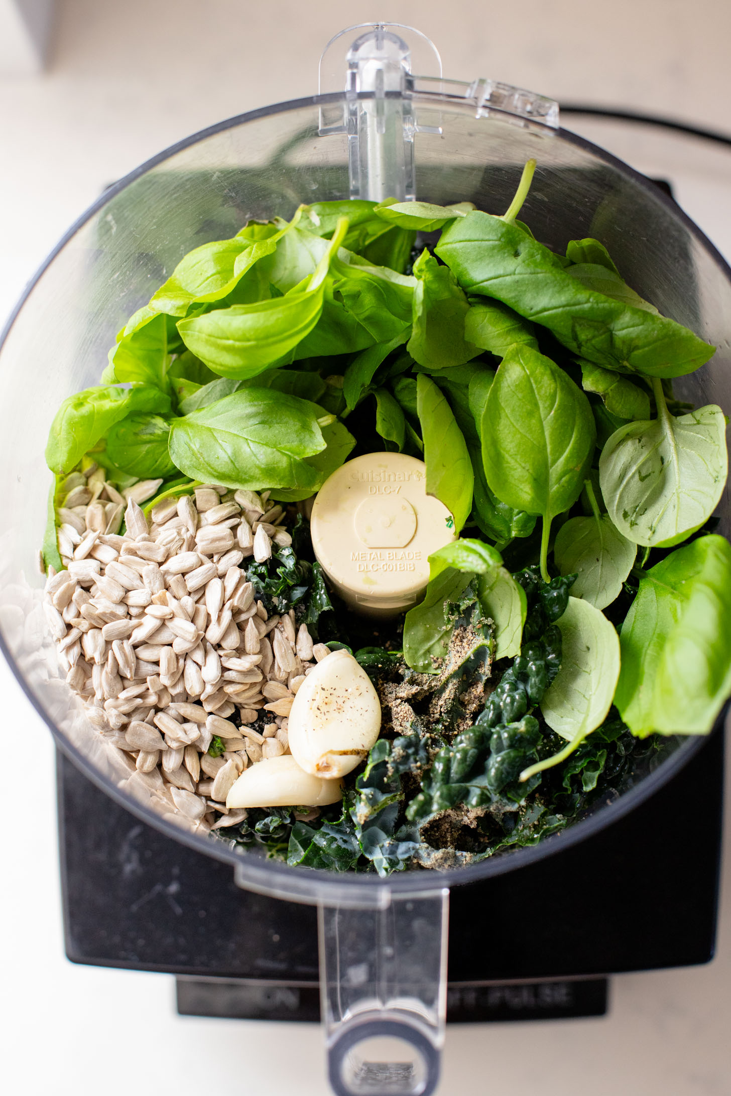 This Kale Pesto Pasta Salad is made with a dairy-free, earthy kale & basil pesto, vegan feta, chickpeas, sun-dried tomatoes & arugula | ThisSavoryVegan.com