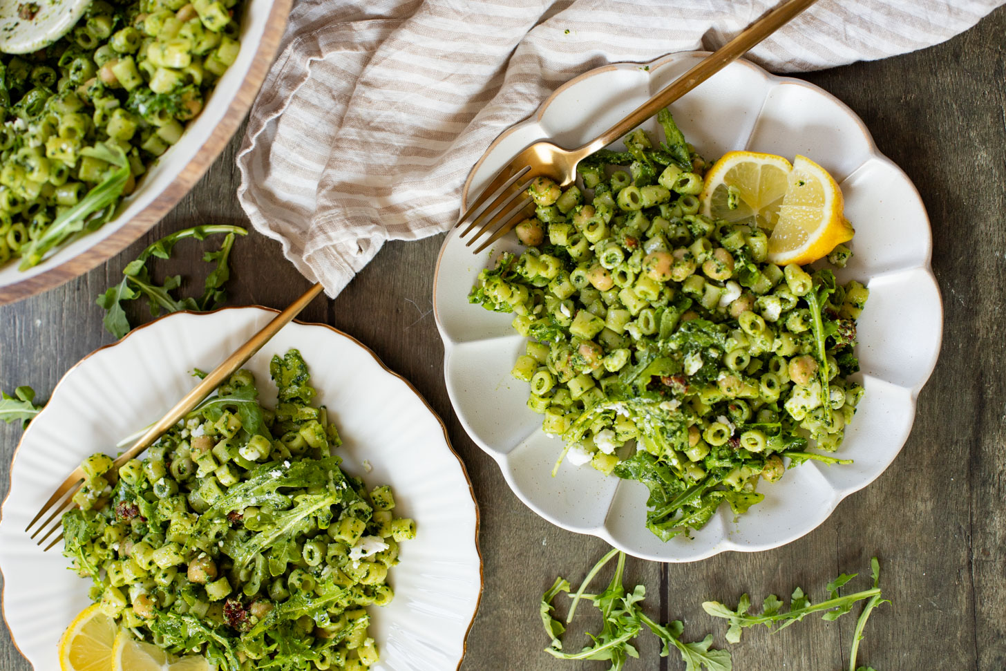 This Kale Pesto Pasta Salad is made with a dairy-free, earthy kale & basil pesto, vegan feta, chickpeas, sun-dried tomatoes & arugula | ThisSavoryVegan.com