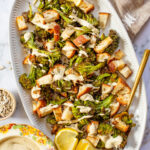 This Roasted Broccoli Salad is layered with crispy shallots & broccoli, garlic croutons, sunflower seeds and lemon tahini dressing | ThisSavoryVegan.com