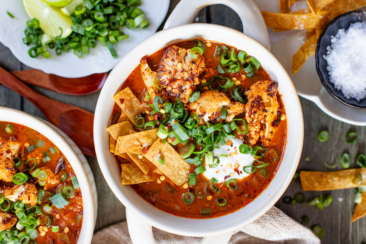 This Roasted Cauliflower Tortilla Soup is cozy and veggie packed! The perfect bowl of soup to warm up with on a cold day | ThisSavoryVegan.com