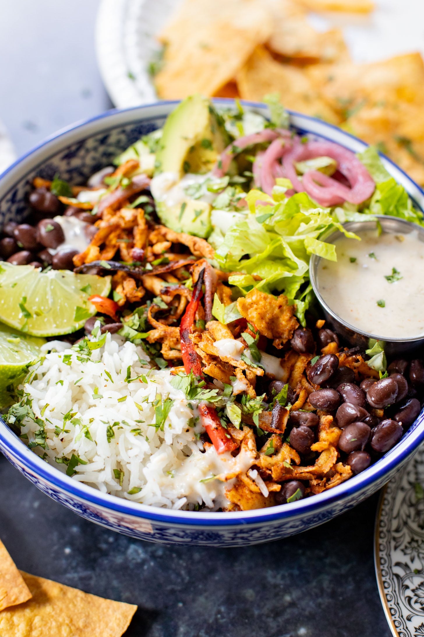These Shredded Tofu Burrito Bowls are high in protein and veggie-packed! Crispy shredded tofu, black beans, veggies & salsa verde yogurt sauce | ThisSavoryVegan.com