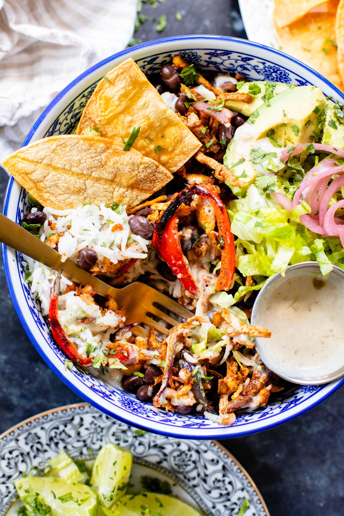 These Shredded Tofu Burrito Bowls are high in protein and veggie-packed! Crispy shredded tofu, black beans, veggies & salsa verde yogurt sauce | ThisSavoryVegan.com