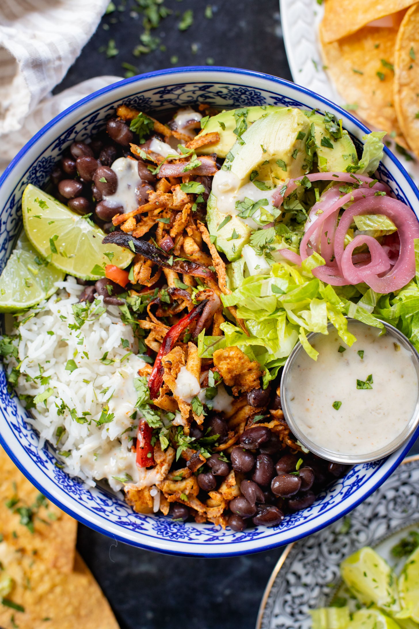 These Shredded Tofu Burrito Bowls are high in protein and veggie-packed! Crispy shredded tofu, black beans, veggies & salsa verde yogurt sauce | ThisSavoryVegan.com