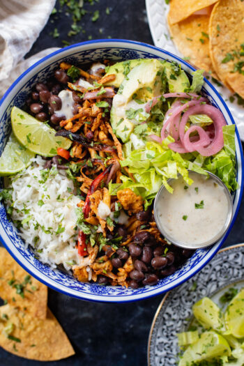 These Shredded Tofu Burrito Bowls are high in protein and veggie-packed! Crispy shredded tofu, black beans, veggies & salsa verde yogurt sauce | ThisSavoryVegan.com