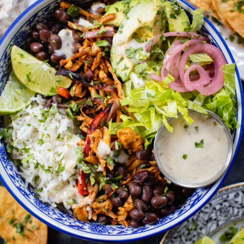 These Shredded Tofu Burrito Bowls are high in protein and veggie-packed! Crispy shredded tofu, black beans, veggies & salsa verde yogurt sauce | ThisSavoryVegan.com