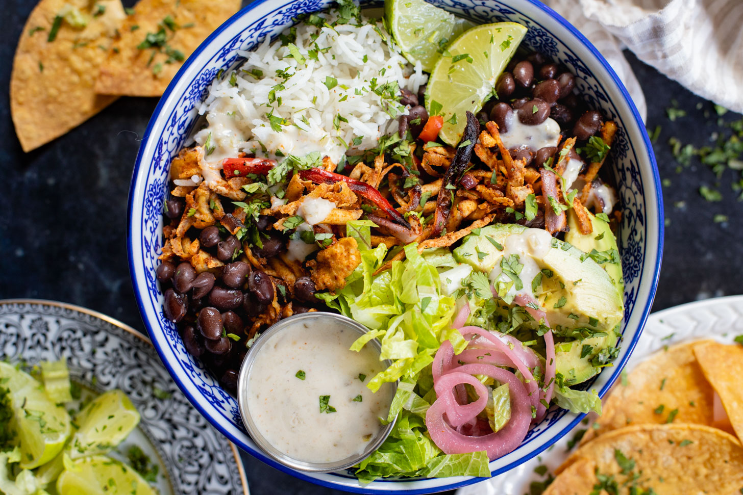 These Shredded Tofu Burrito Bowls are high in protein and veggie-packed! Crispy shredded tofu, black beans, veggies & salsa verde yogurt sauce | ThisSavoryVegan.com