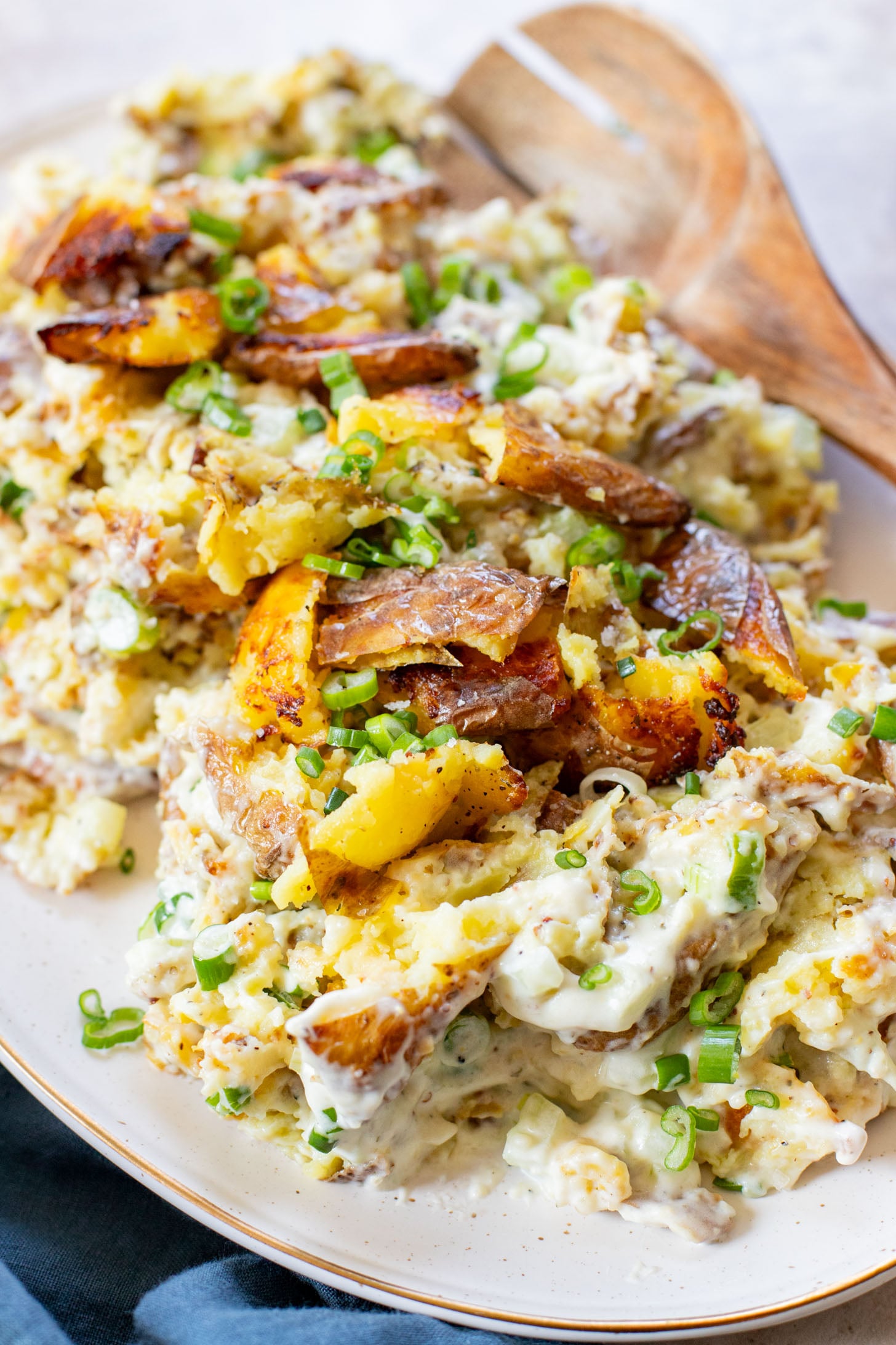 This Vegan Smashed Potato Salad is made with Yukon gold potatoes that are crisped up in the oven and tossed in a dairy-free dressing | ThisSavoryVegan.com