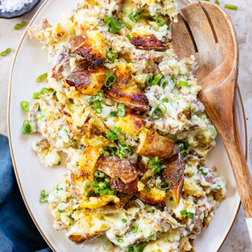 This Vegan Smashed Potato Salad is made with Yukon gold potatoes that are crisped up in the oven and tossed in a dairy-free dressing | ThisSavoryVegan.com
